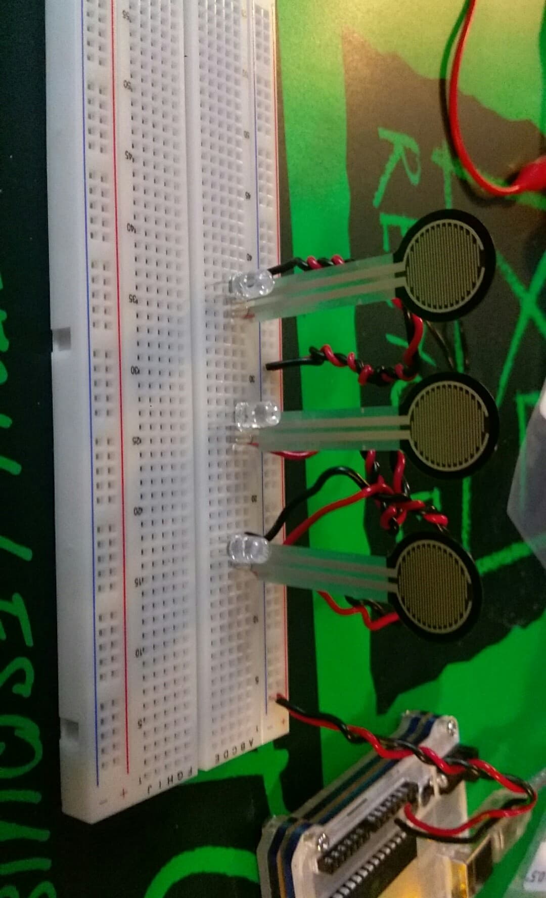 Three Force-Sensitive Resistors in a prototyping circuitboard with corresponding LEDs